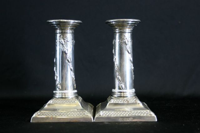 Appraisal: A pair of Edwardian sterling silver candlesticks by Thomas Bradbury