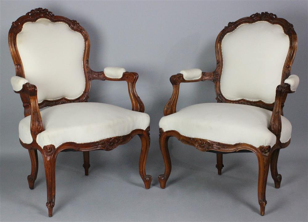 Appraisal: PAIR OF CARVED CHERRYWOOD LOUIS XV STYLE OPEN ARM CHAIRS