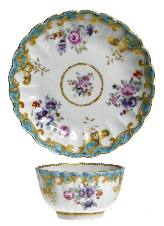 Appraisal: A FIRST PERIOD WORCESTER FLUTED TEA BOWL AND SAUCER enamelled