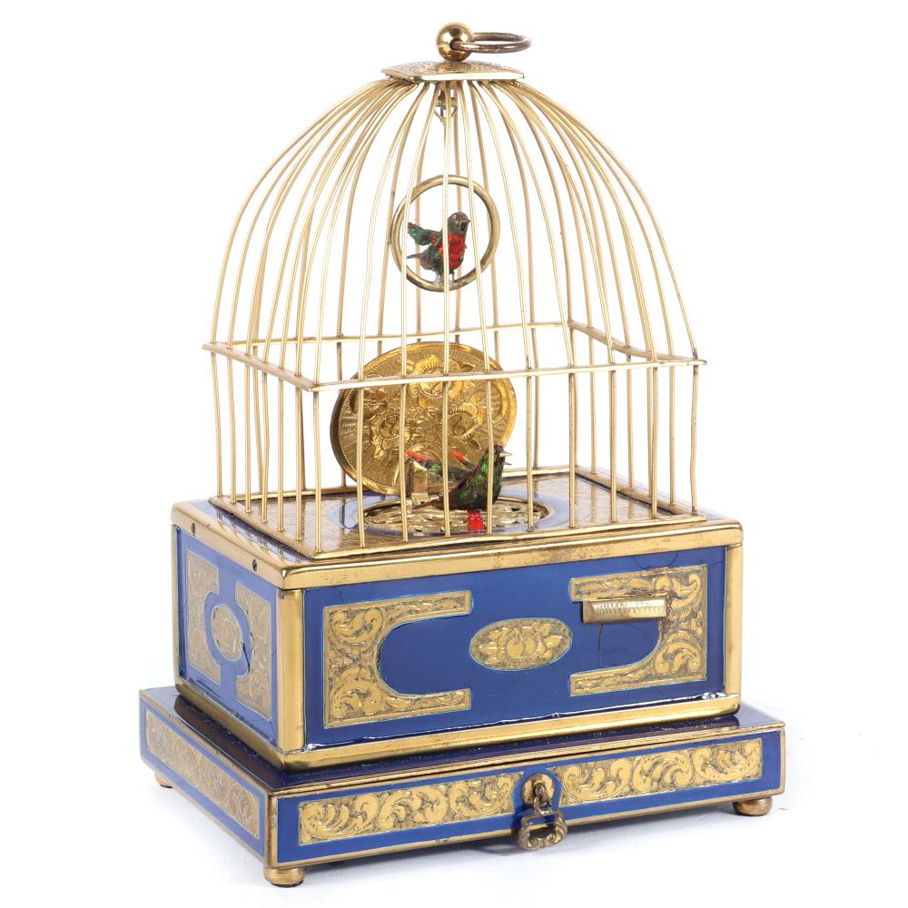 Appraisal: GERMAN CLOCKWORK BIRD BOX WITH CAGE AUTOMATON GILT AND BLUE