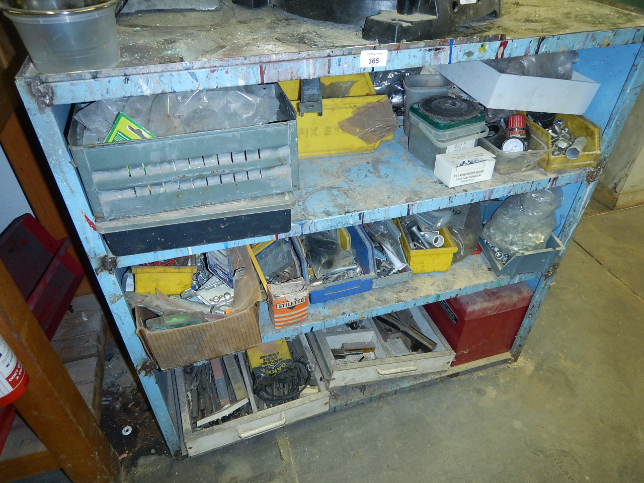 Appraisal: A steel framed three tier workbench numerous nuts bolts components