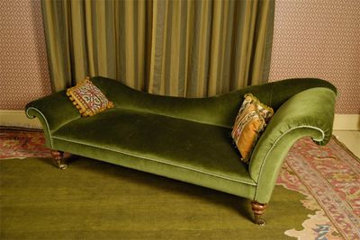 Appraisal: A Victorian upholstered day bed scroll ends with turned legs