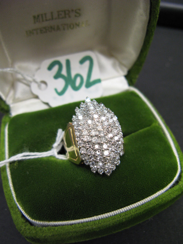 Appraisal: DIAMOND AND FOURTEEN KARAT YELLOW AND WHITE GOLD CLUSTER RING