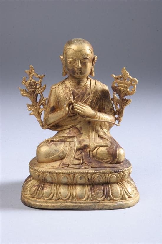 Appraisal: CHINESE GILT BRONZE FIGURE OF MONK Seated on a double