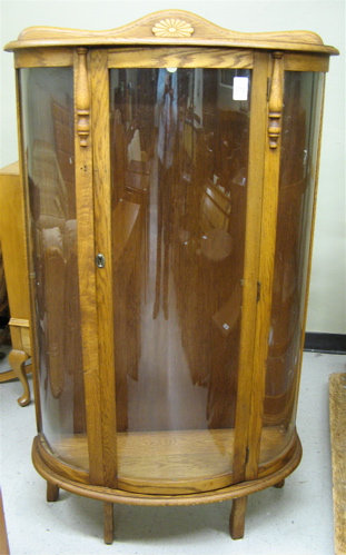 Appraisal: AN OAK AND CURVED GLASS CHINA DISPLAY CABINET American th