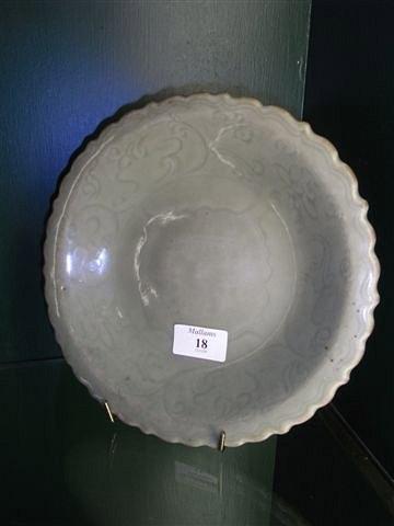 Appraisal: A CHINESE MING CELADON DISH with barbed rim edge and