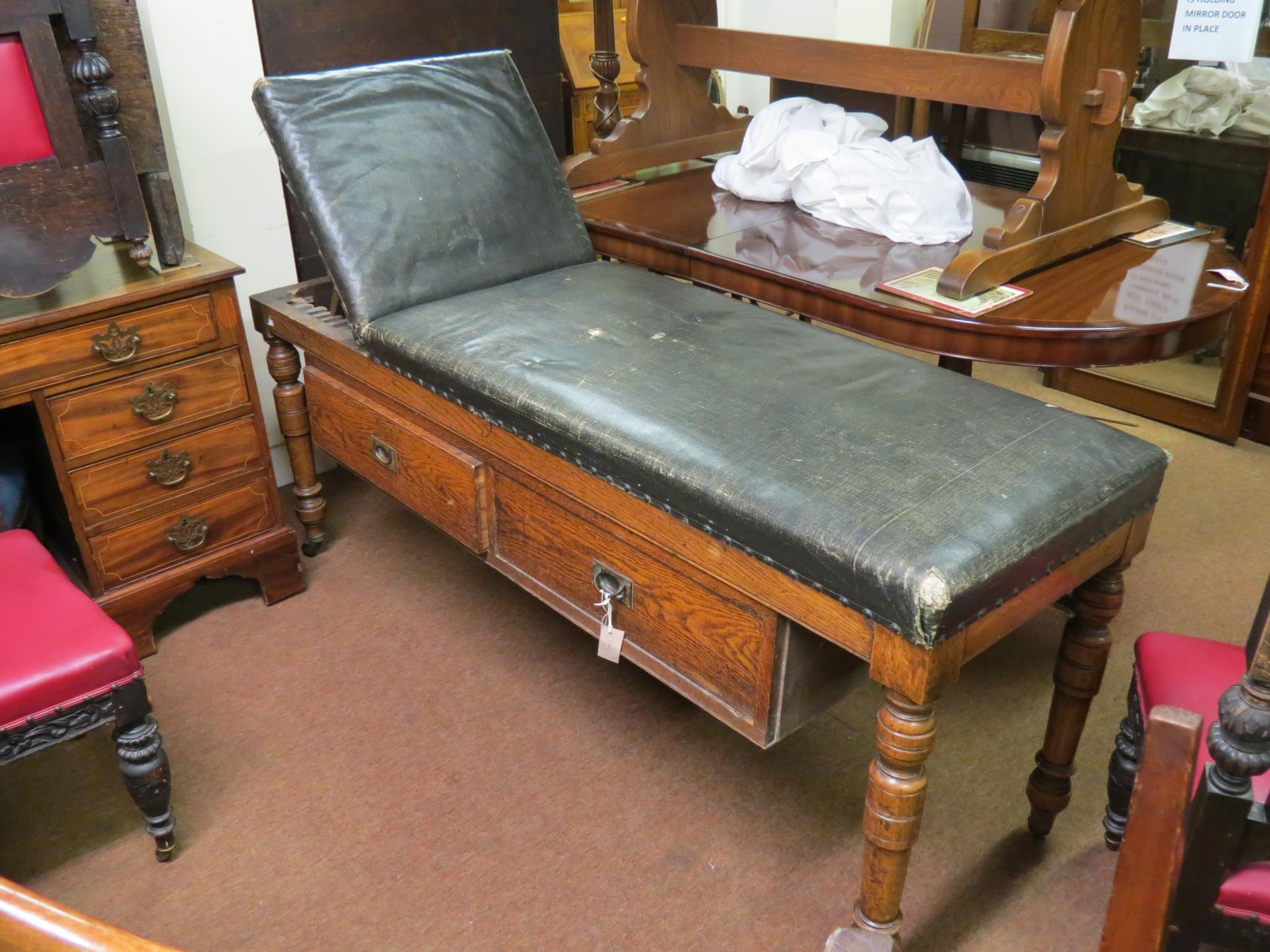 Appraisal: An early th century doctor's examination couch upholstered top with