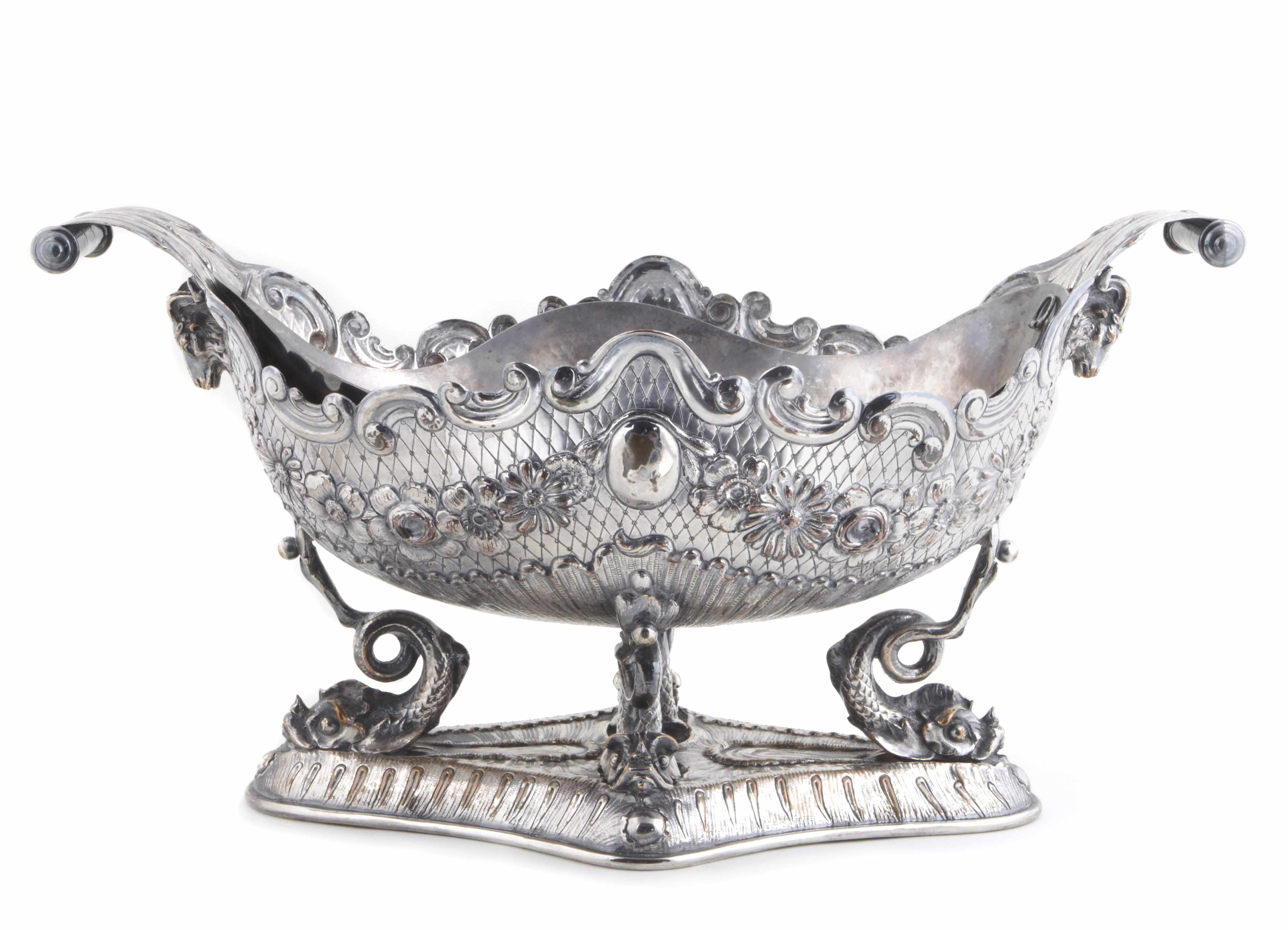 Appraisal: A continental plated figural centerpiece th century Shaped lozenge form