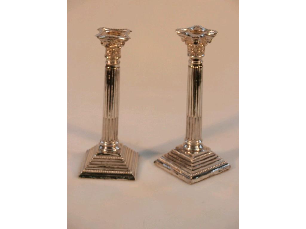 Appraisal: A pair of George V silver composite column table candlesticks