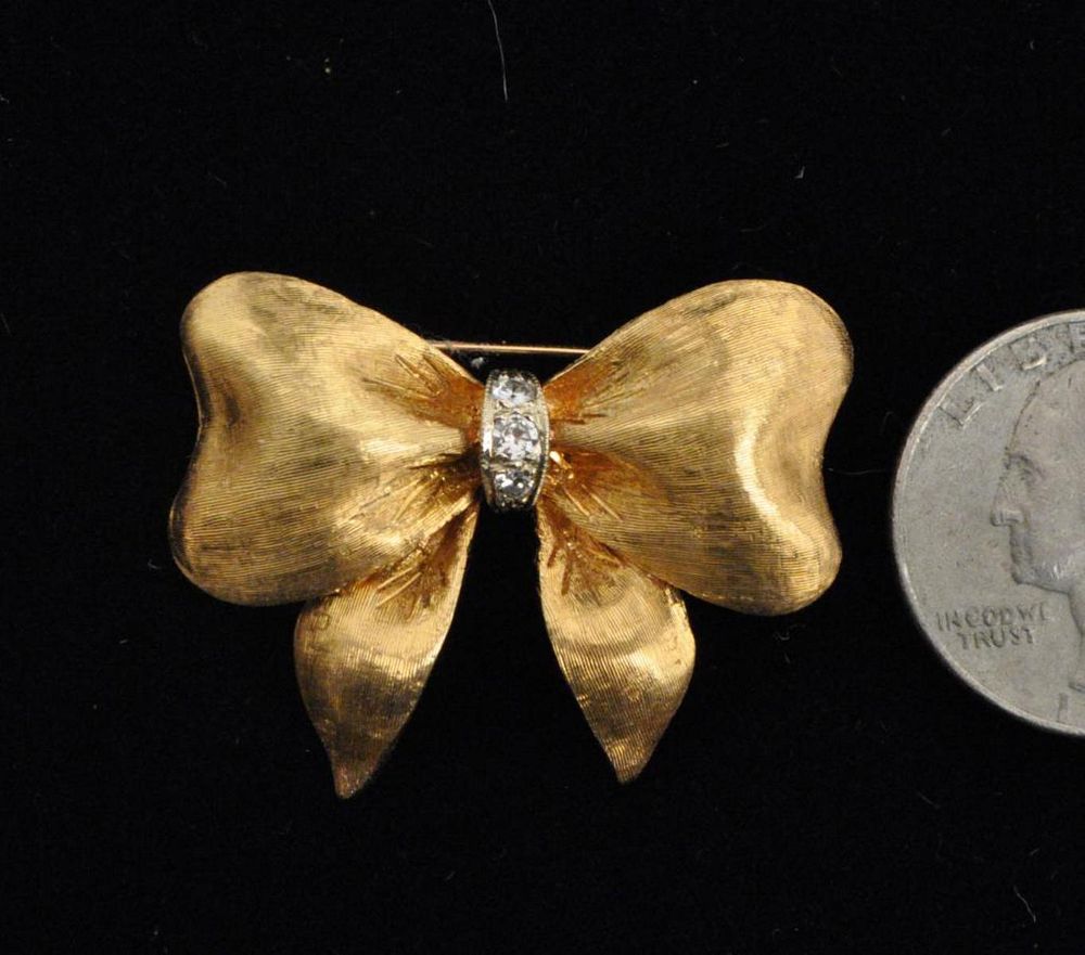 Appraisal: K Gold Diamond Ribbon Form Pin with three small diamonds