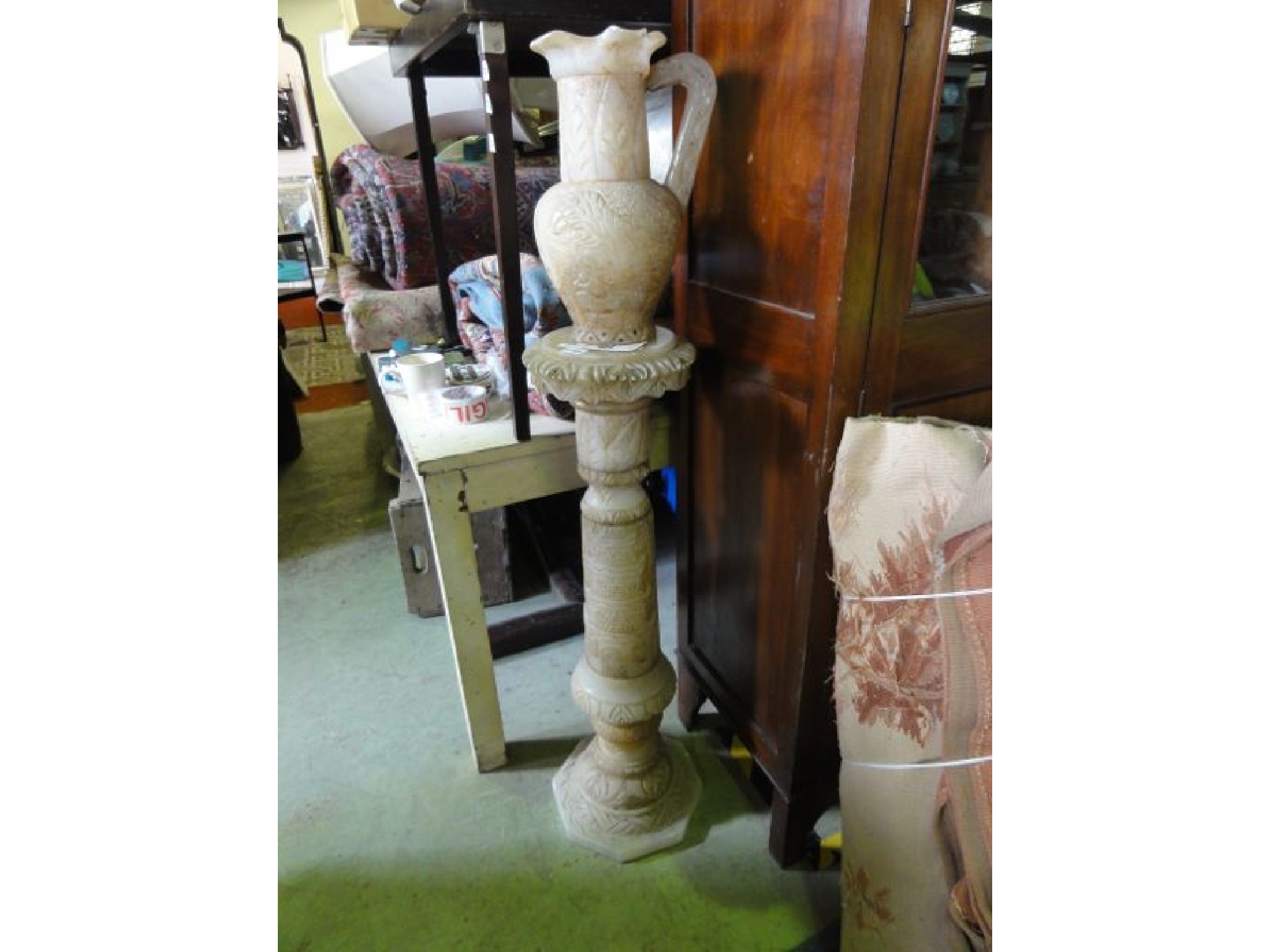 Appraisal: A carved alabaster column with pagoda floral and further detail