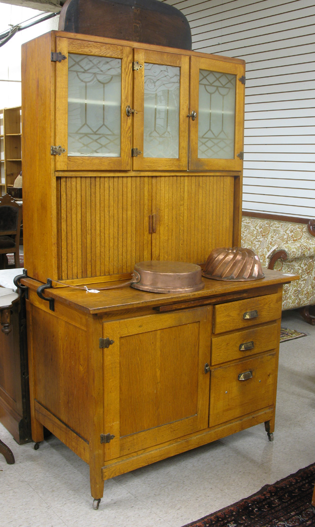 Appraisal: AN OAK 'HOOSIER' KITCHEN CABINET American early th century in