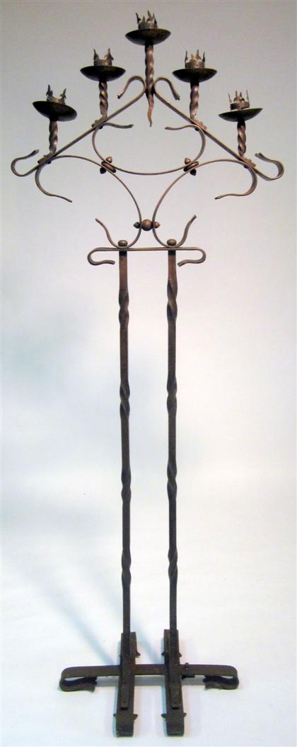 Appraisal: Baroque style wrought iron candelabrum The twisted standard issuing five