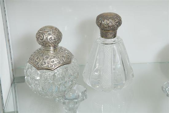 Appraisal: TWO GLASS AND SILVER PERFUME BOTTLES One profusely embellished perfume