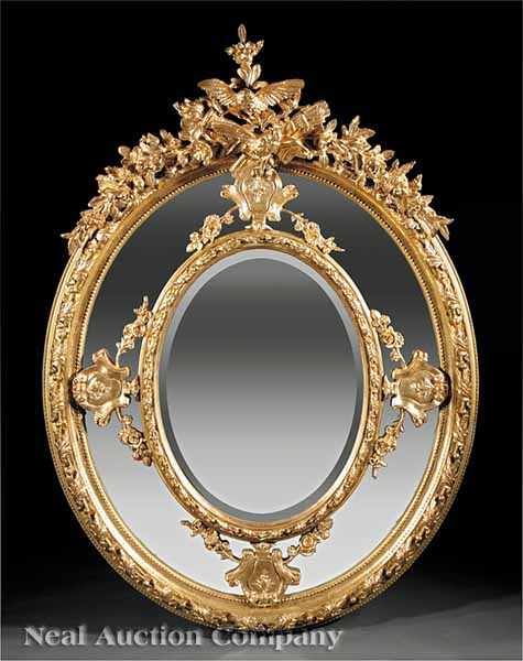 Appraisal: A Monumental Antique Louis XVI-Style Carved Giltwood Mirror elaborate carved