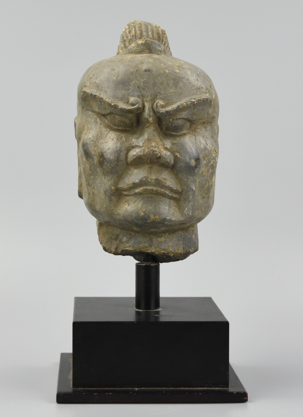 Appraisal: CHINESE STONE CARVED HEAD OF A STERN MALE FACE A