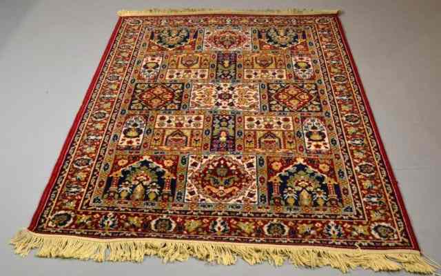 Appraisal: A Small Persian RugWith geometric designs in reds blues and