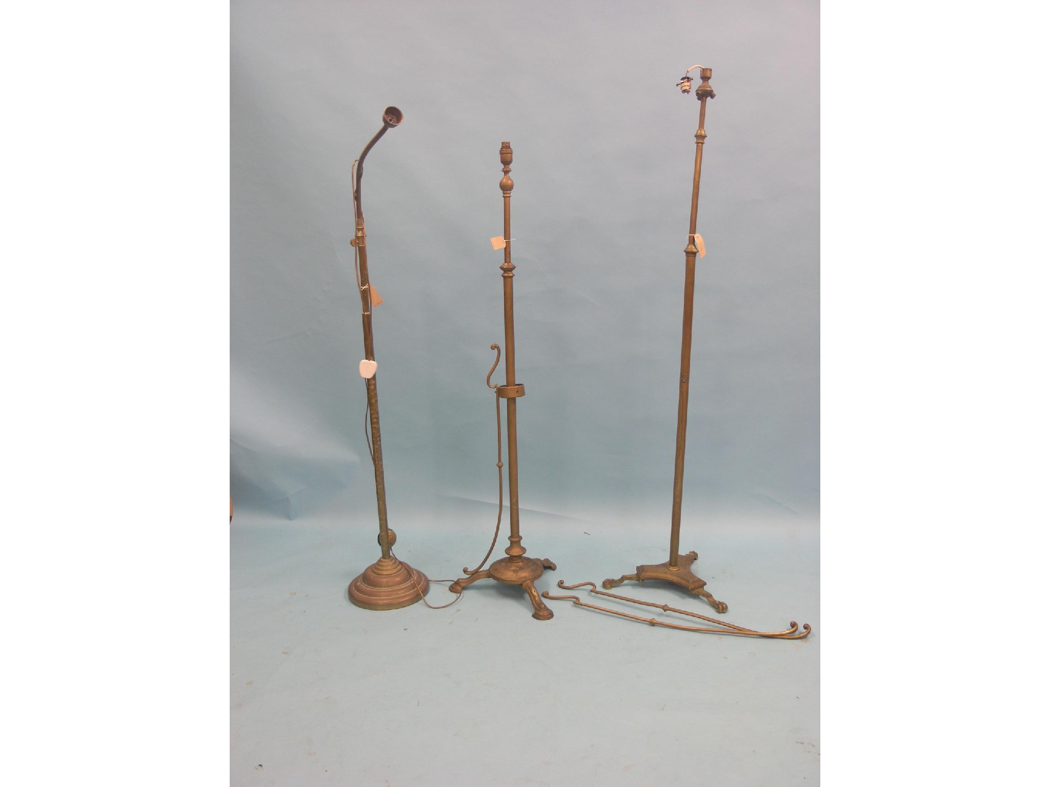 Appraisal: Three various brass floor lamps one with adjustable angle-poise as