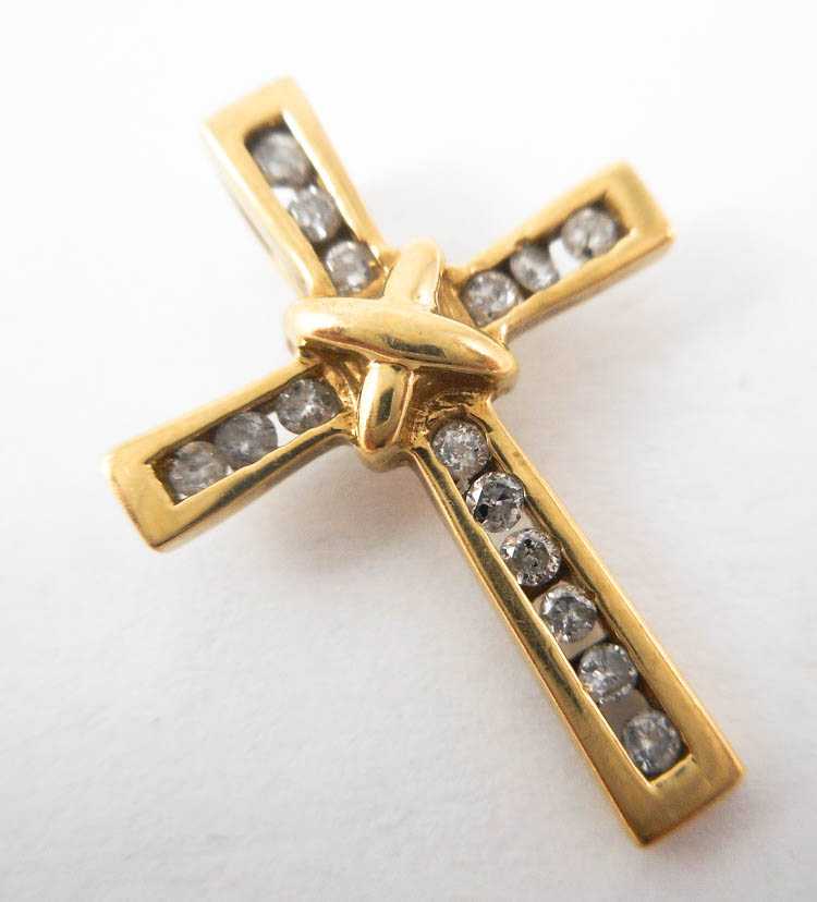 Appraisal: DIAMOND AND TEN KARAT GOLD CROSS PENDANT with channel set