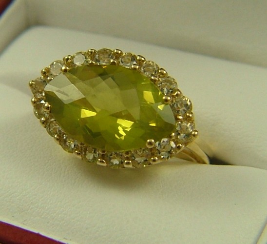 Appraisal: YELLOW BERYL AND FOURTEEN KARAT GOLD RING centering a checkerboard-cut