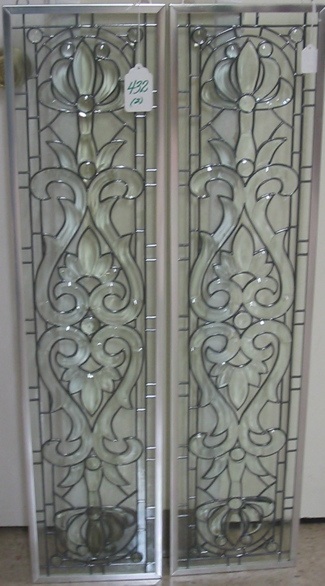 Appraisal: PAIR BEVELED GLASS WINDOW PANELS The stylized floral motif in