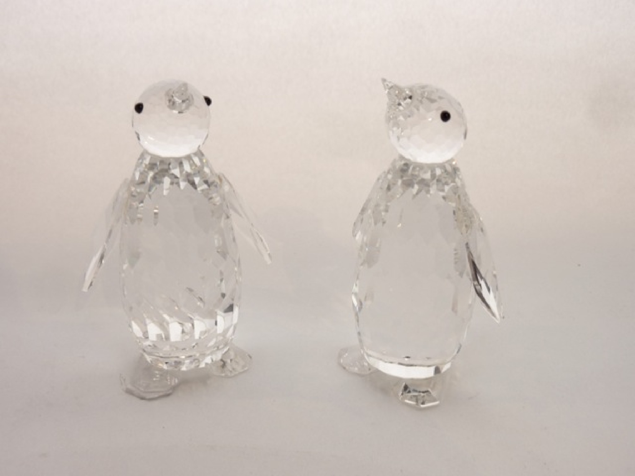 Appraisal: A pair of Swarovski Crystal models of standing penguins each