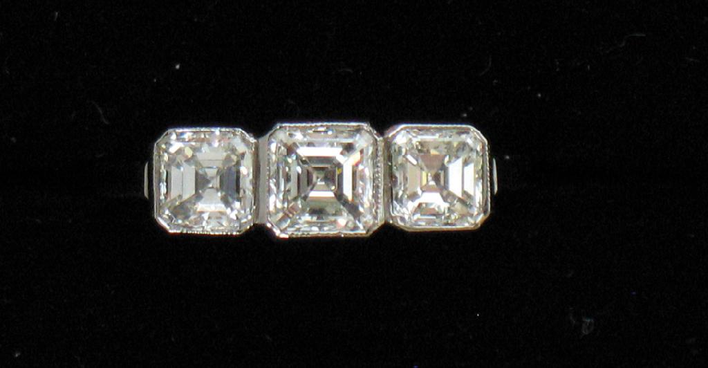 Appraisal: A THREE STONE DIAMOND RING the three graduated square-cut diamonds