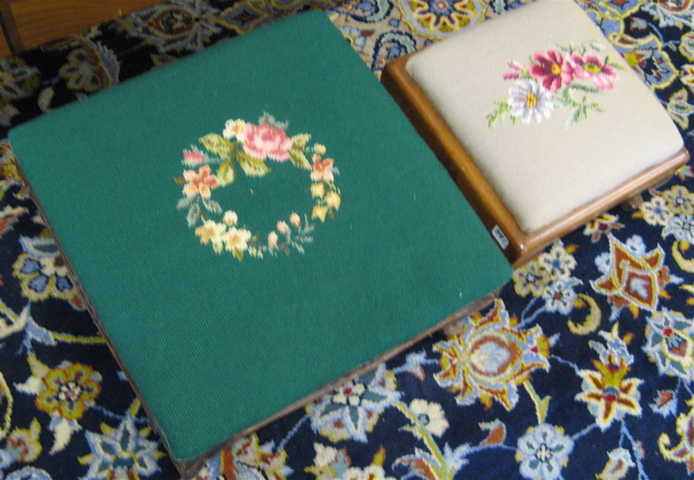 Appraisal: TWO SQUARE NEEDLEPOINT FOOTSTOOLS American th century The larger version