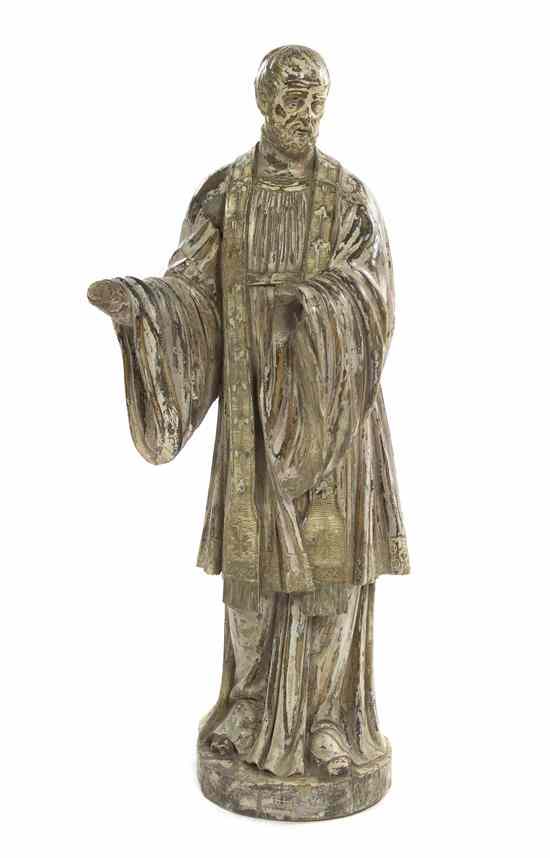 Appraisal: A Continental Carved Wood Figure depicting a standing saint with