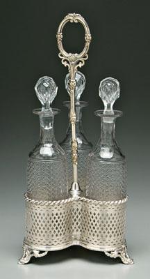 Appraisal: Cut glass decanter set silver plated caddy with three-lobe base