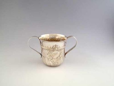 Appraisal: An early George III embossed porringer with twin reeded handles