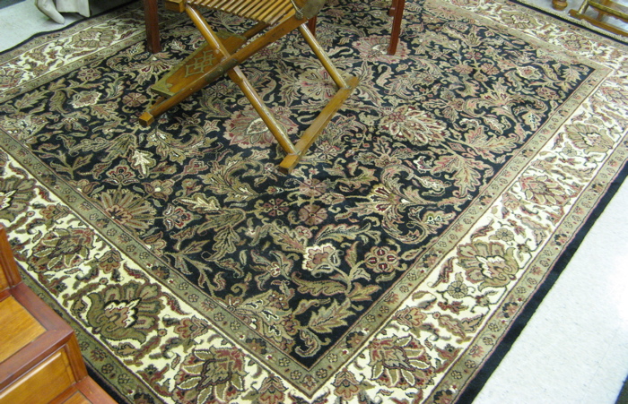 Appraisal: HAND KNOTTED ORIENTAL CARPET Indo-Persian overall floral decoration on black