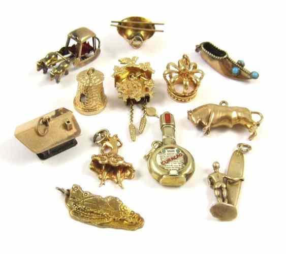 Appraisal: TWELVE YELLOW GOLD CHARMS including nine k gold charms weighing