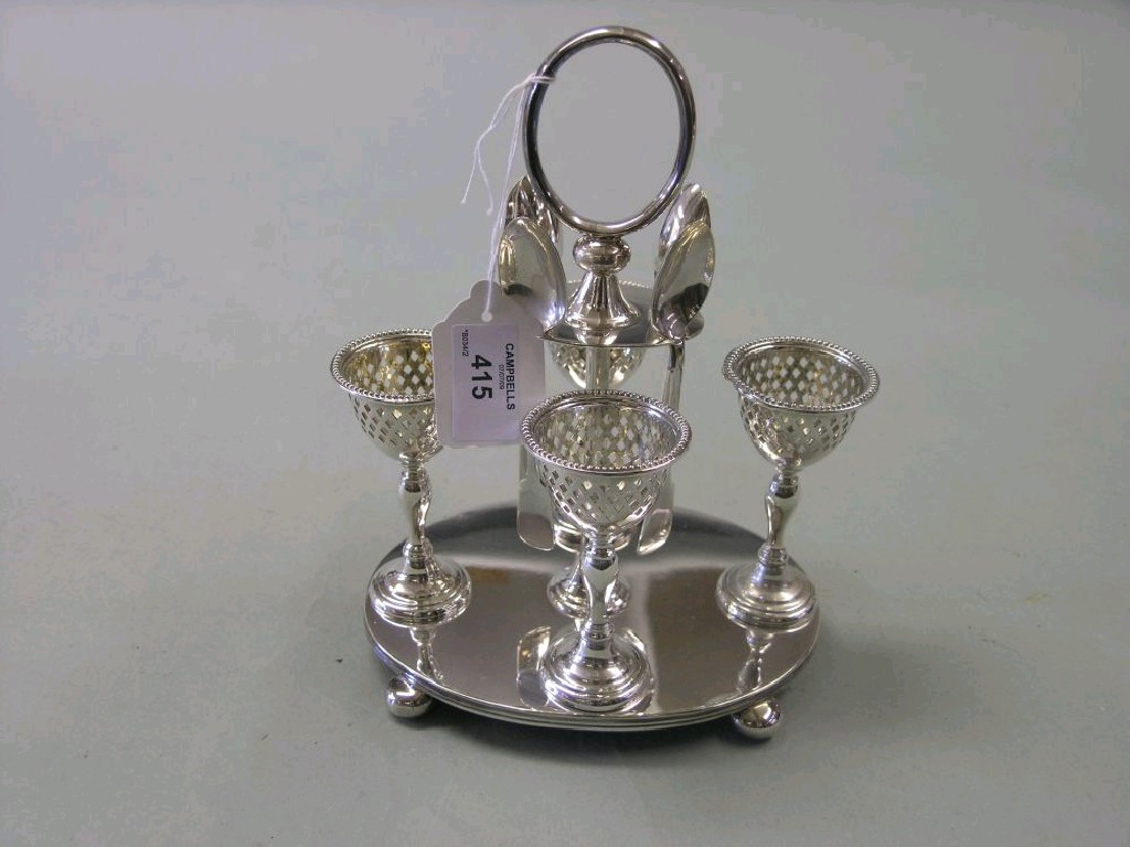 Appraisal: A silver plated four-cup egg cruet complete with egg spoons