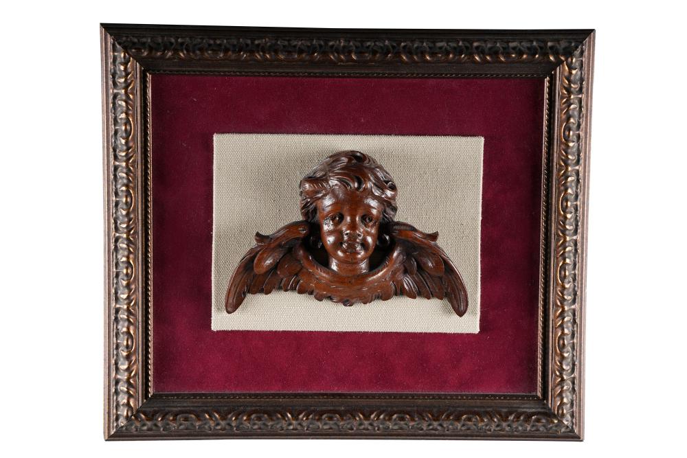 Appraisal: CARVING OF A CHERUBwood carving mounted and framed Condition good