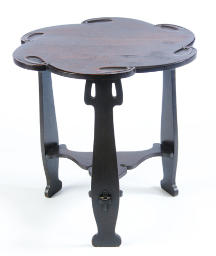 Appraisal: CHARLES ROHLFS Floriform table with carved top reticulated legs and