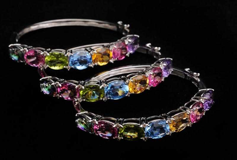 Appraisal: THREE K WHITE GOLD COLORED STONE AND DIAMOND BANGLE BRACELETS