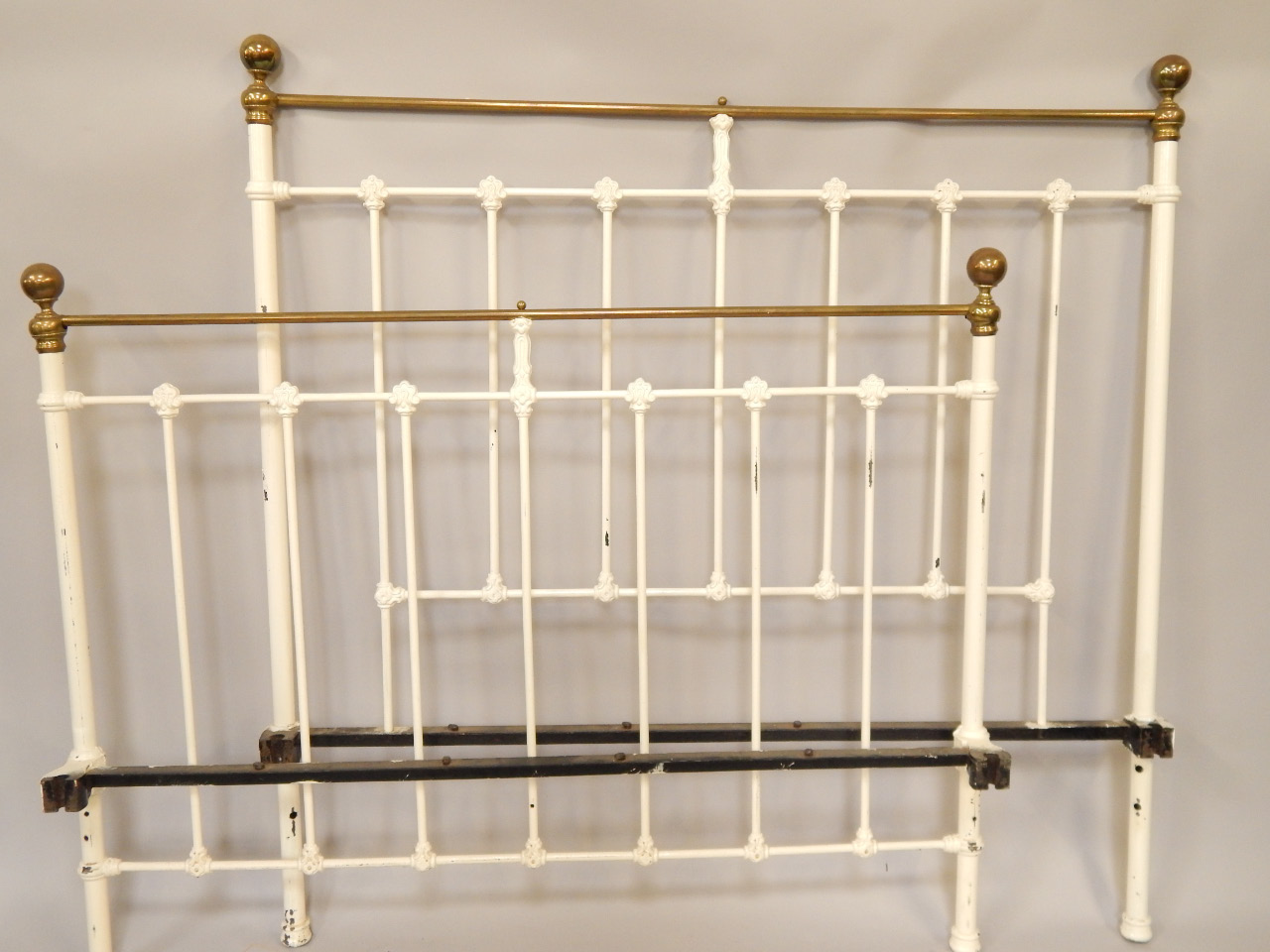 Appraisal: A white painted cast iron bed with brass fittings and