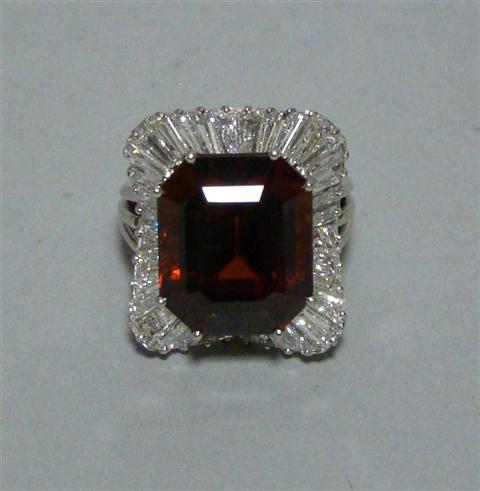 Appraisal: BALLERINA STYLE GARNET AND DIAMOND RING Emerald cut garnet approx