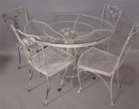 Appraisal: WROUGHT IRON CIRCULAR GARDEN TABLE WITH FOUR CHAIRS the glass