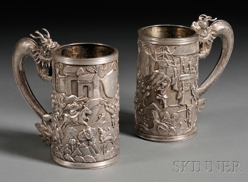 Appraisal: Pair of Chinese Export Dragon Figural-handled Repousse Silver Mugs mid-to-late