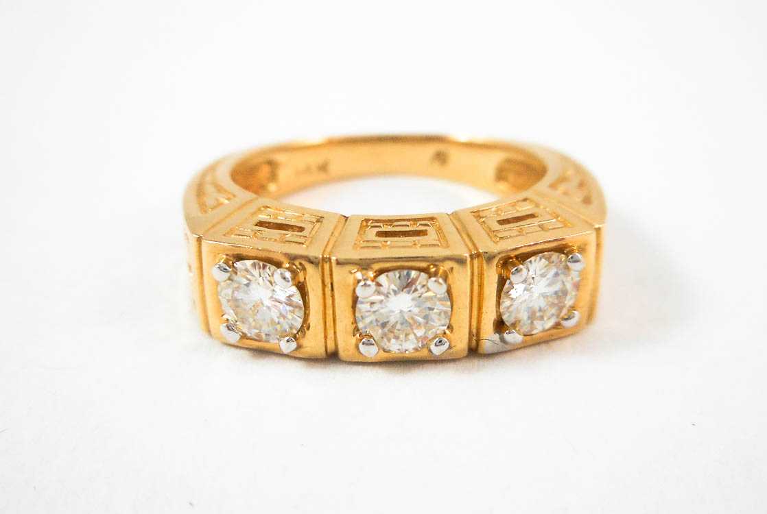 Appraisal: MOISSANITE AND FOURTEEN KARAT GOLD RING set with three round-cut