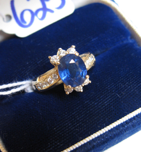 Appraisal: SAPPHIRE DIAMOND AND FOURTEEN KARAT GOLD RING round-cut diamonds are