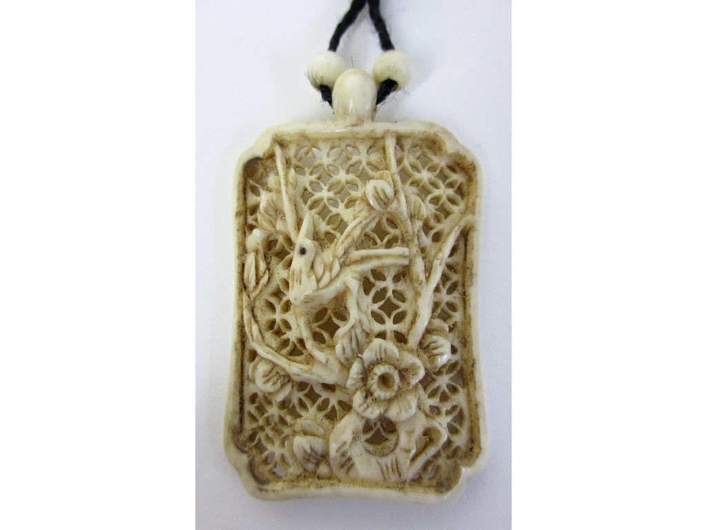 Appraisal: A Chinese carved ivory pendant decorated with a bird and