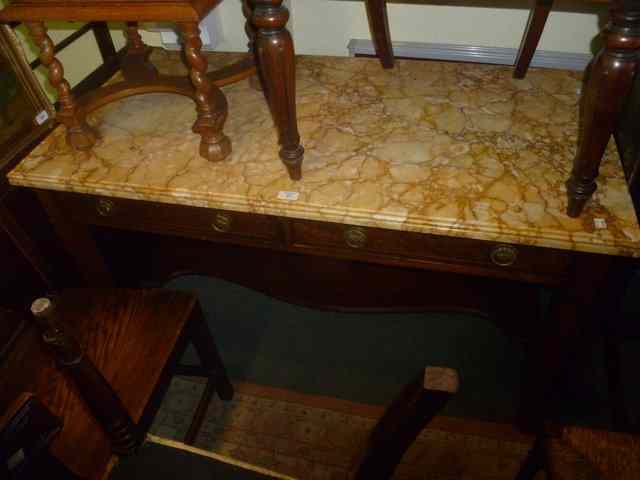 Appraisal: A CONTINENTAL MARBLE TOP WASH STAND with raised and shaped