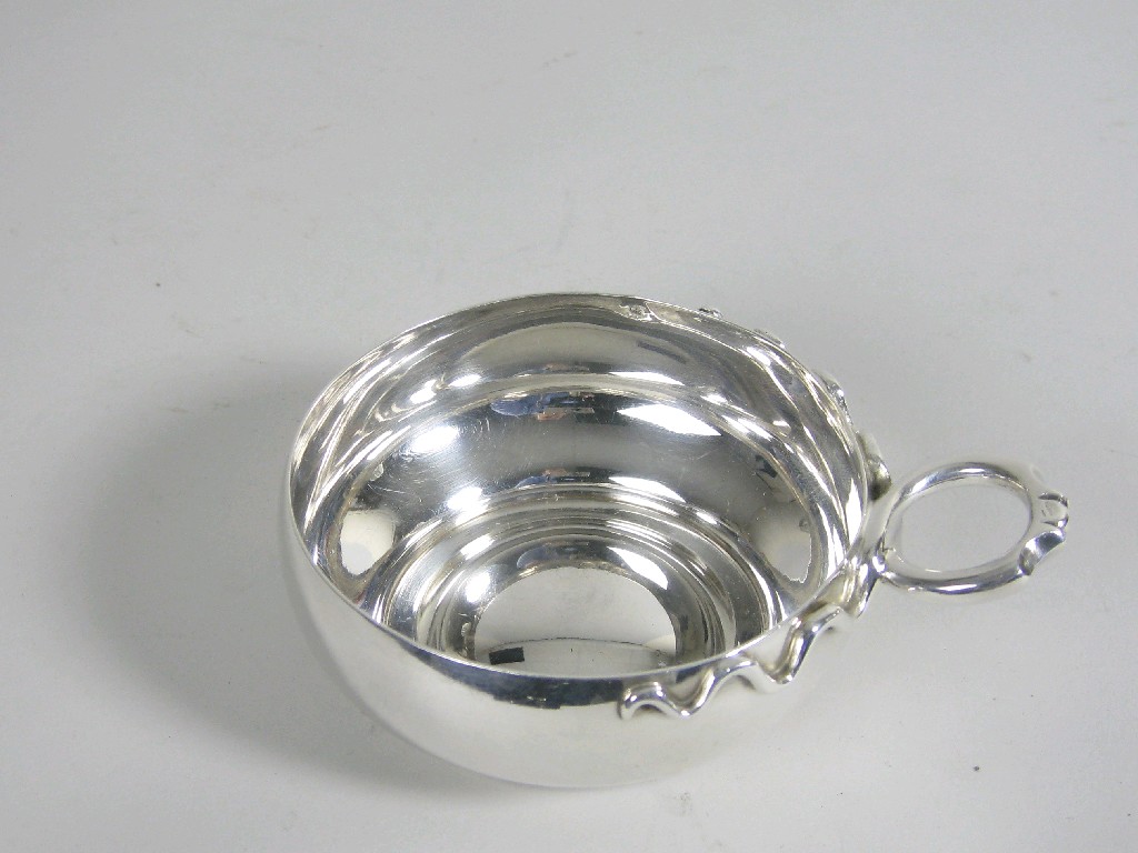 Appraisal: A French silver Tastevin with coiled single handle inscription under