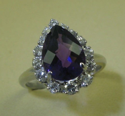 Appraisal: AMETHYST AND FOURTEEN KARAT GOLD RING set with a pear