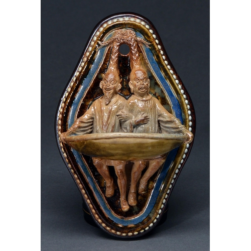 Appraisal: George Tinworth A rare Doulton ware figural wall pocket in