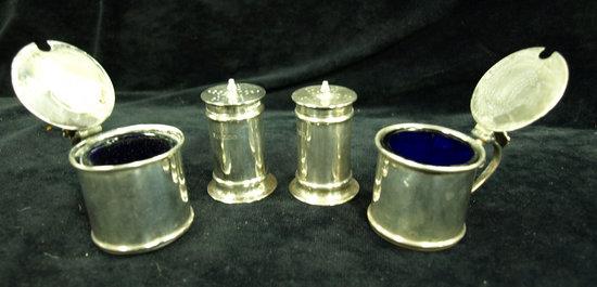 Appraisal: A pair of cylindrical pepper pots with pierced covers and