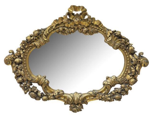 Appraisal: French giltwood mirror early th c cartouche-shaped frame with ribbon